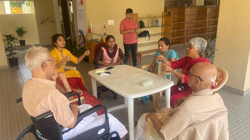 Elders and staff around a table discussing and sharing